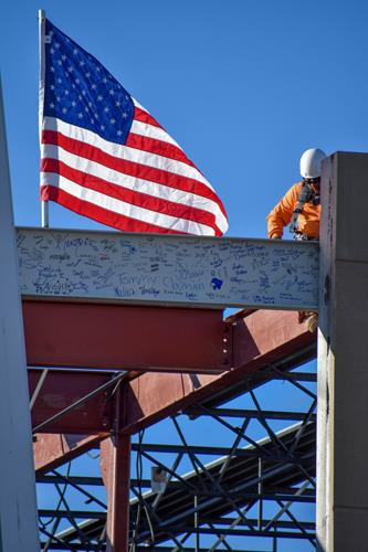 Worker installs the Signed beam